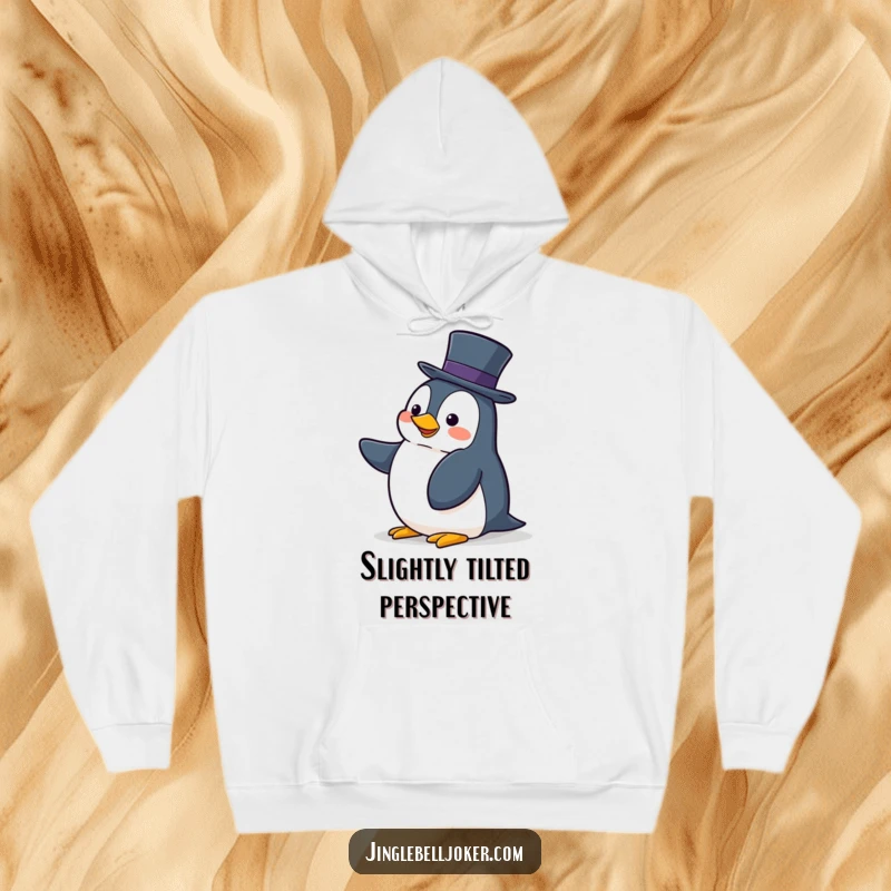 Funny hoodie depicting a clumsy penguin enthusiastically struggling to balance a tall hat, ideal for cozy moments.