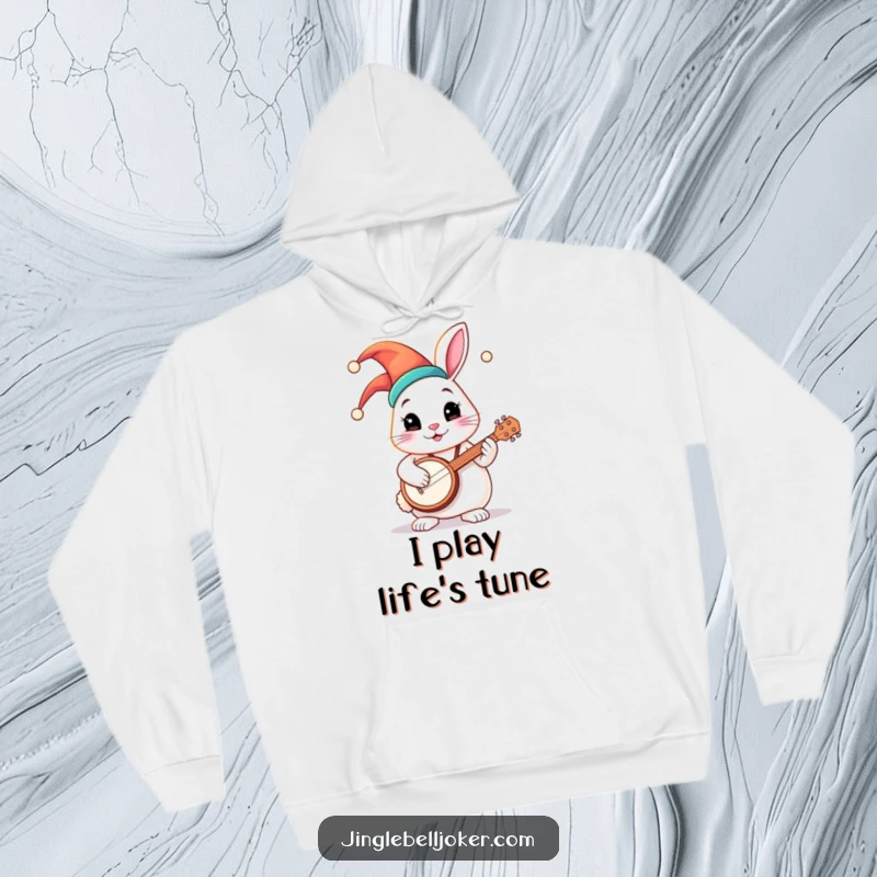Funny hoodie featuring a round, chubby bunny character in a vibrant jester hat, strumming a tiny banjo with a look of pure delight.