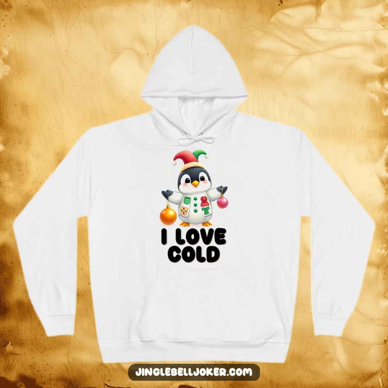 Funny hoodie showcasing a fluffy penguin in a jester hat juggling festive Christmas baubles, embodying playful holiday spirit.
