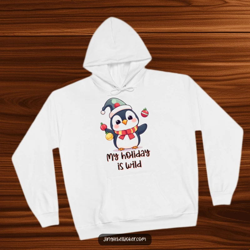 Funny Penguin Hoodie: Cute penguin in a jester hat juggling colorful Christmas ornaments, warm and humorous.