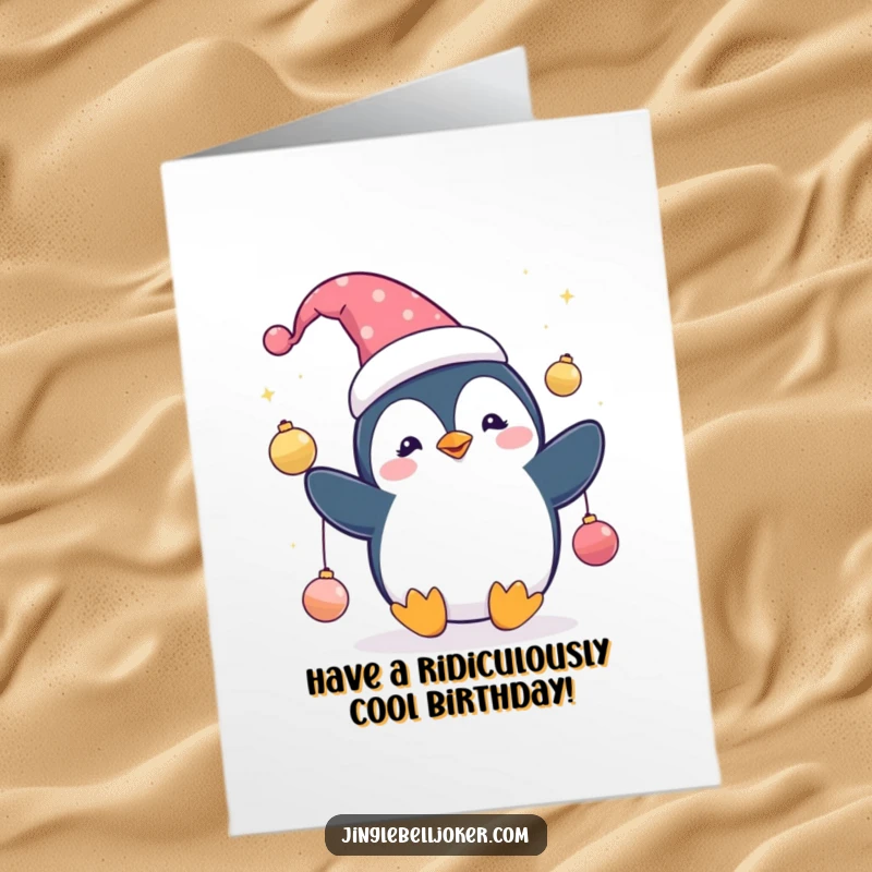 Funny Free Printable Birthday Card: A cute penguin in a jester hat, skillfully juggling shiny ornaments with a playful grin.